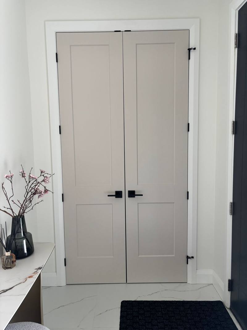 8 ft white shaker-panel closet doors with black bar handles installed in an Ottawa home