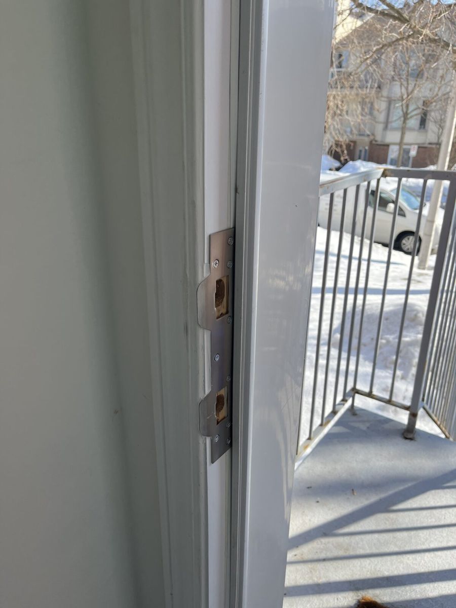 New multipoint lock keepers installed in a reinforced white door frame in Ottawa