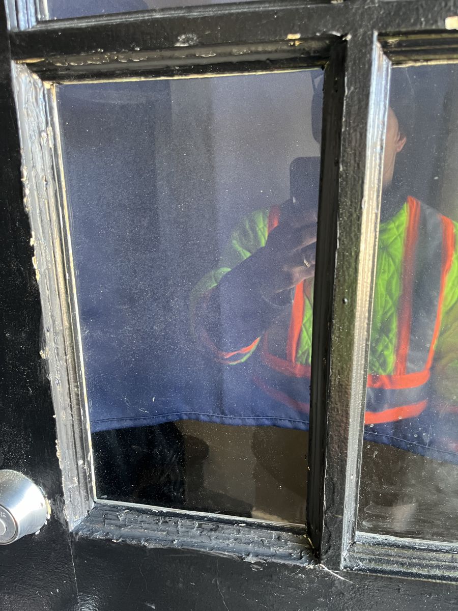 The same Ottawa entry door with a new glass pane installed, secure and clear