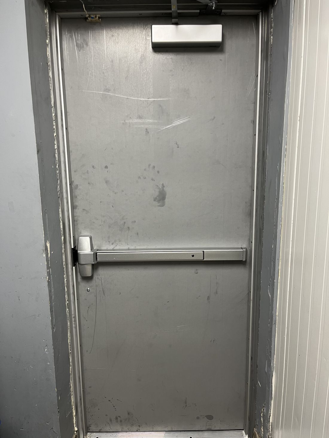 Panic bar exit hardware serviced on a commercial door in Ottawa