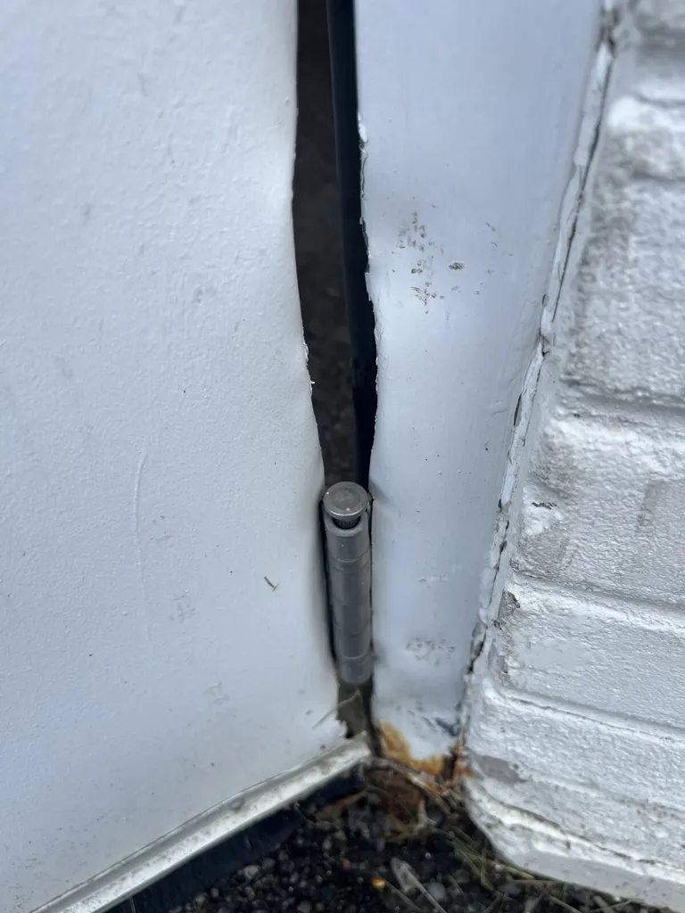 Commercial steel door hinge and jamb gap during repair in Ottawa