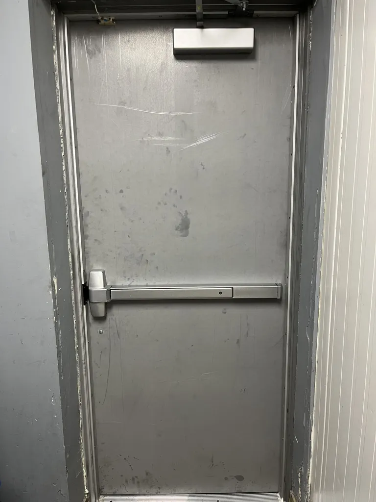 Panic bar lock repair on a commercial exit in Ottawa