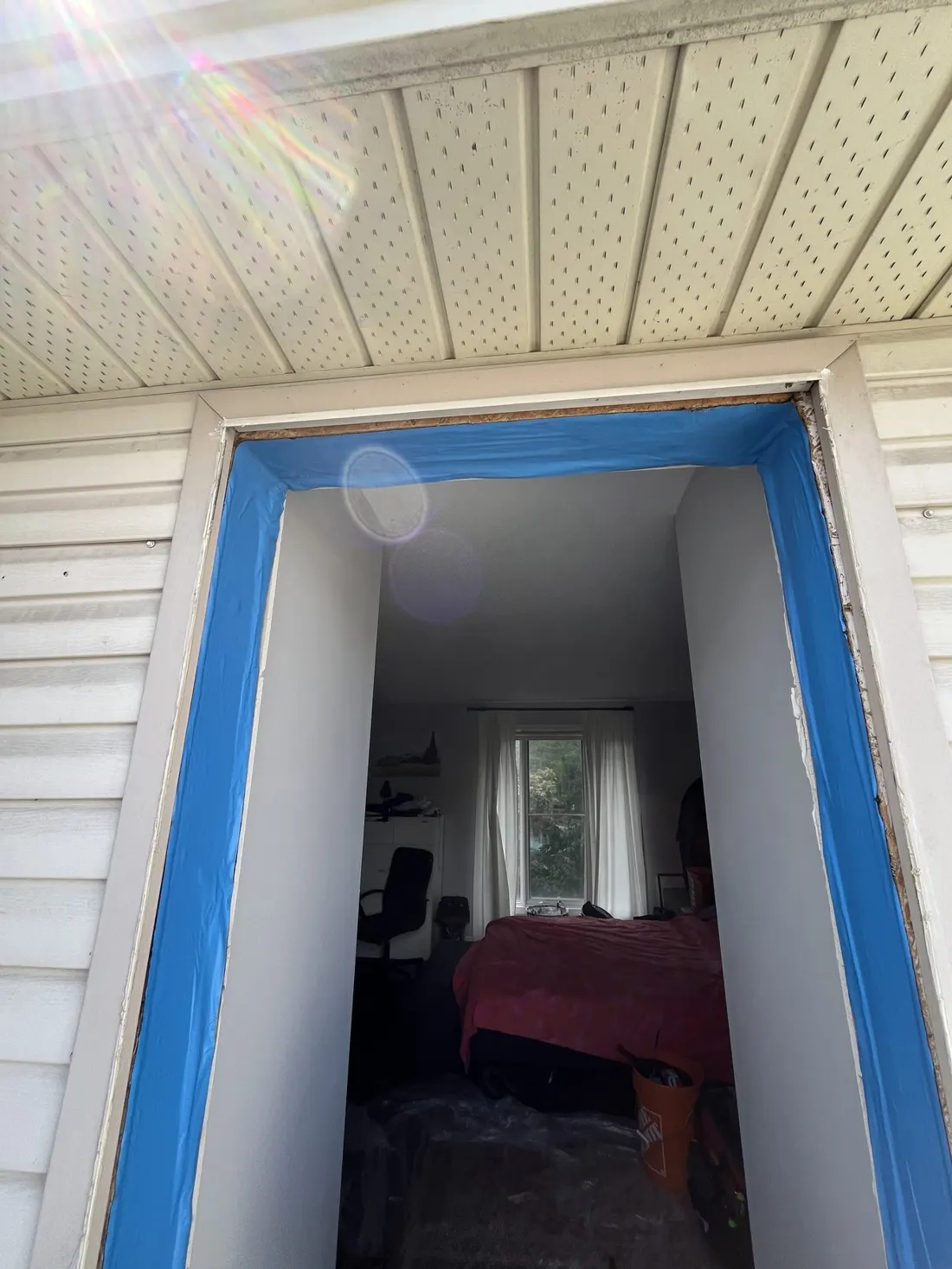 Exterior door opening taped and sealed along the jambs before the new door is installed