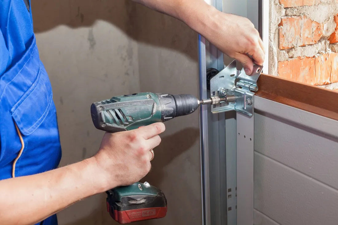 Garage door track and panel work during a sectional door service visit